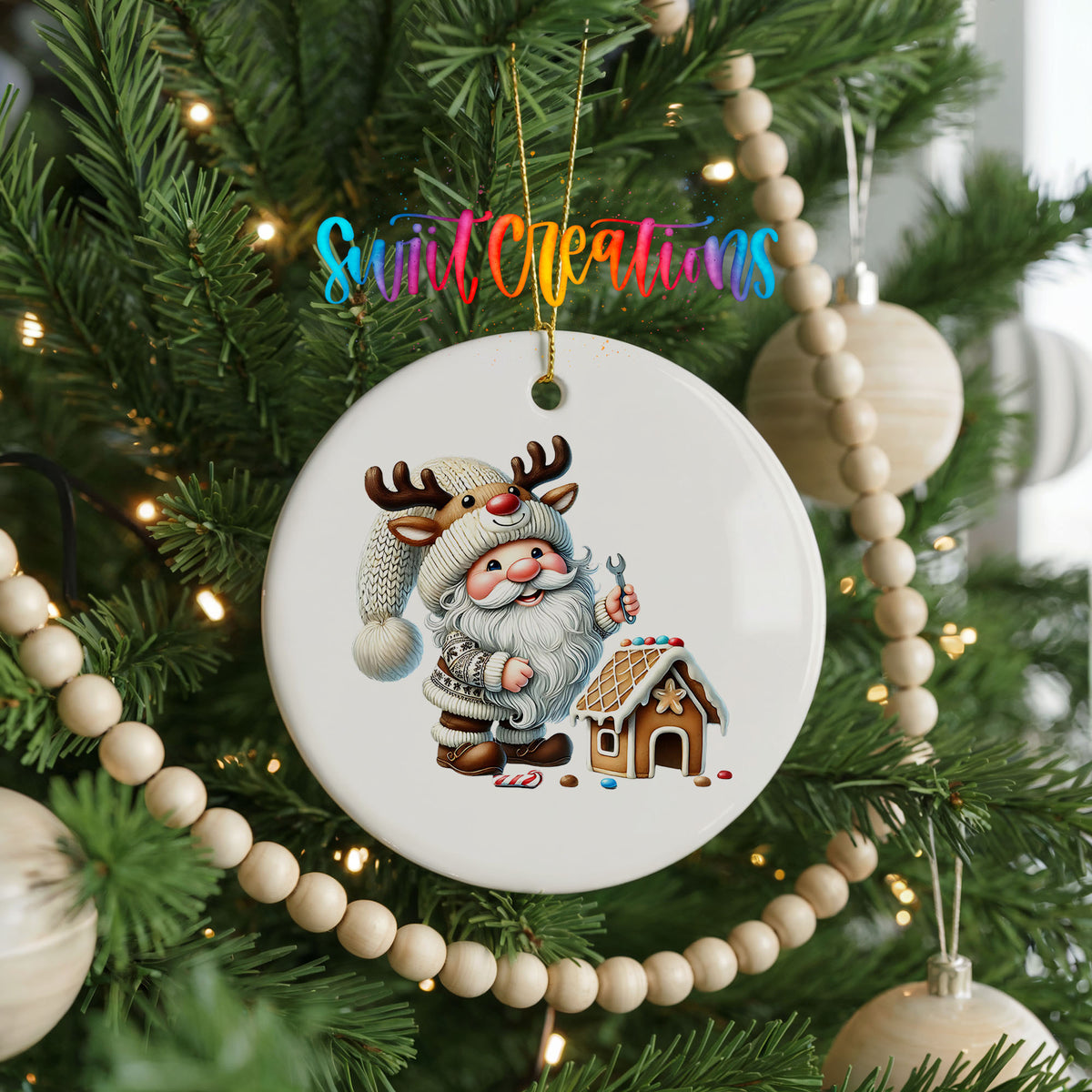Santa decorating a gingerbread house ceramic Christmas ornament hanging on a decorated Christmas tree