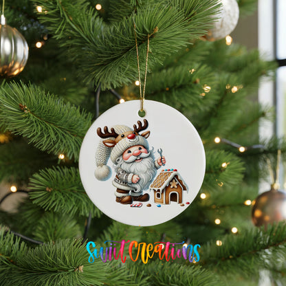 Santa decorating a gingerbread house ceramic Christmas ornament hanging on a green Christmas tree