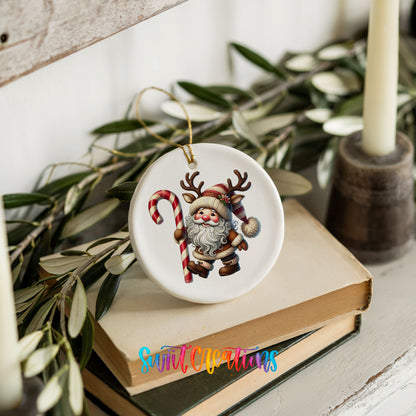 Santa holding an oversized candy cane ceramic Christmas ornament styled on books with holiday greenery