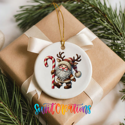 Santa holding an oversized candy cane ceramic Christmas ornament arranged on a wrapped Christmas gift