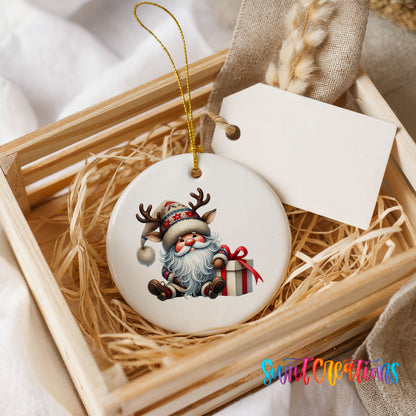 Santa sitting beside a wrapped Christmas gift ceramic Christmas ornament displayed in a rustic wooden gift crate