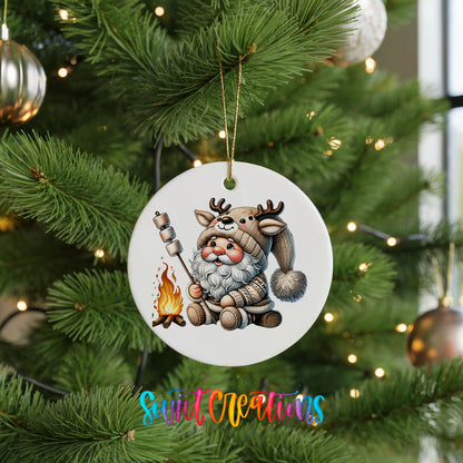 Santa roasting a marshmallow by a campfire ceramic Christmas ornament hanging on a green Christmas tree