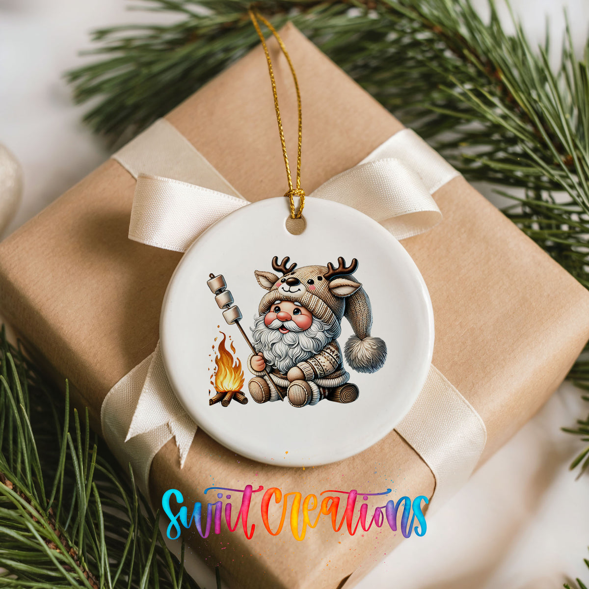 Santa roasting a marshmallow by a campfire ceramic Christmas ornament arranged on a wrapped Christmas gift