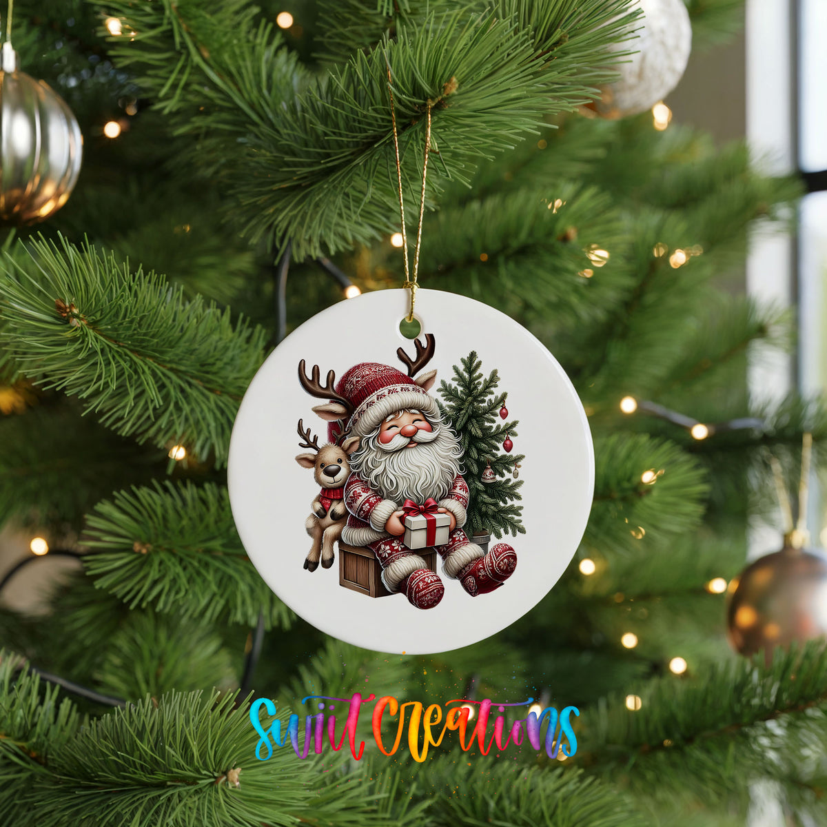 Round ceramic Christmas ornament featuring Santa with a reindeer beside a decorated Christmas tree, hanging on a green Christmas tree