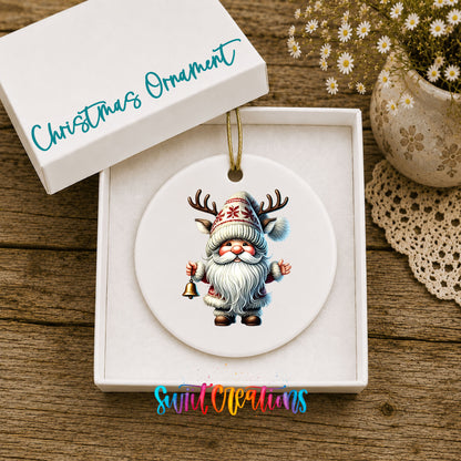Round ceramic Christmas ornament featuring Santa ringing a Christmas handbell, displayed in the included gift box