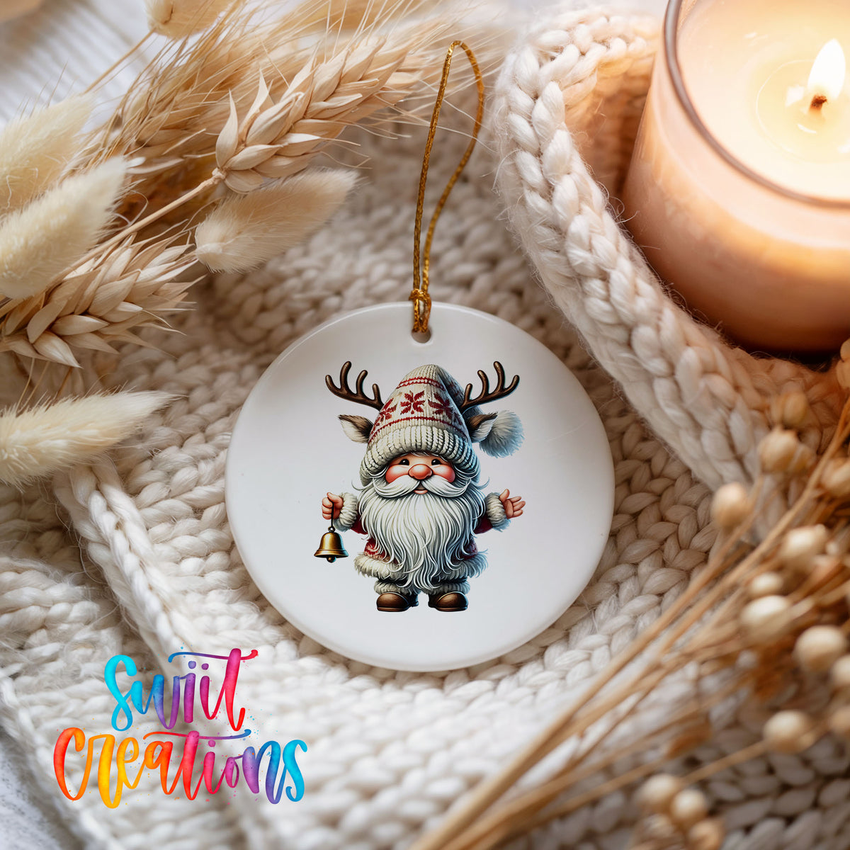 Round ceramic Christmas ornament featuring Santa ringing a Christmas handbell, styled beside a candle and cozy knit blanket