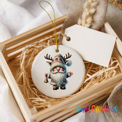 Round ceramic Christmas ornament featuring Santa ringing a Christmas handbell, presented in a rustic wooden gift crate
