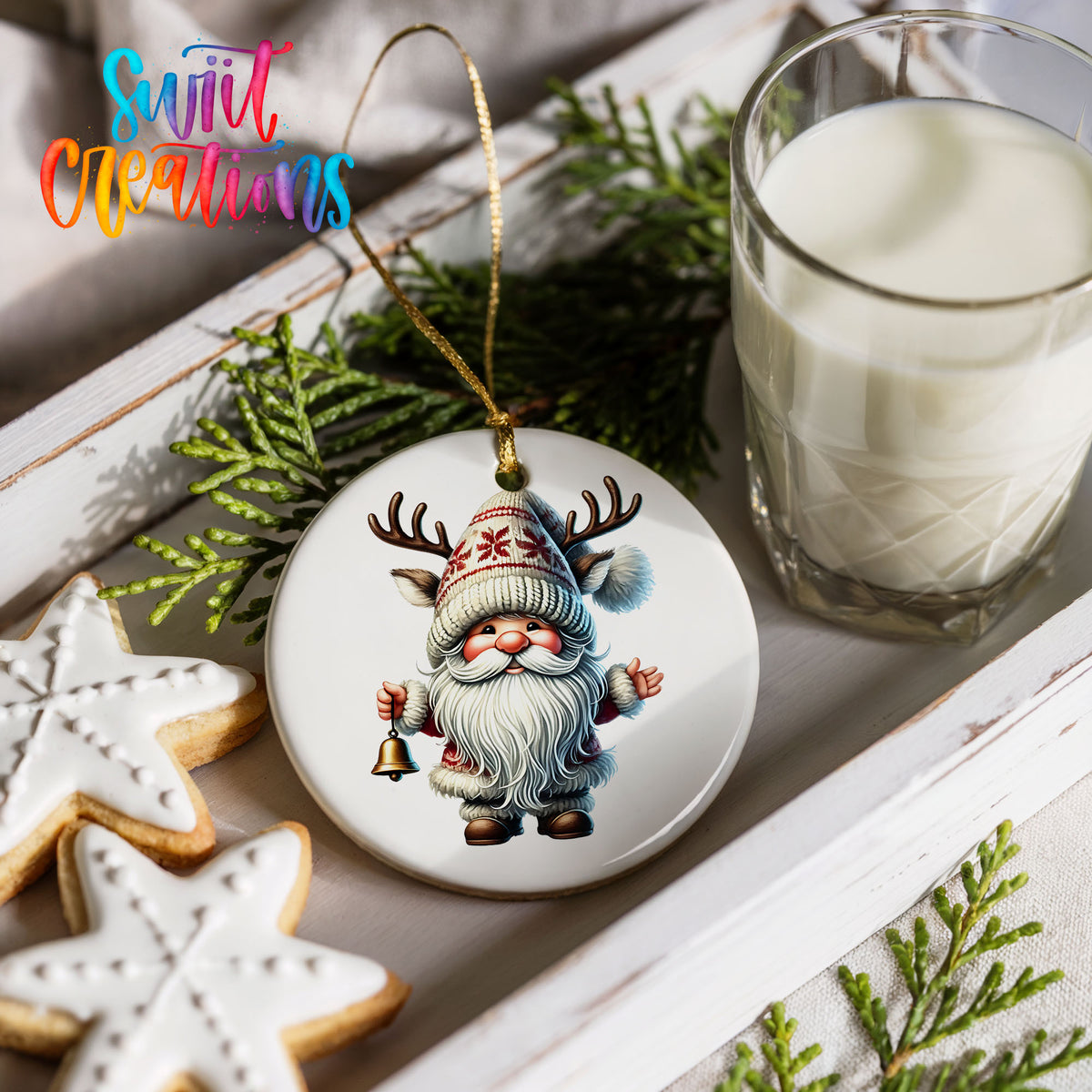 Round ceramic Christmas ornament featuring Santa ringing a Christmas handbell, styled with cookies and milk