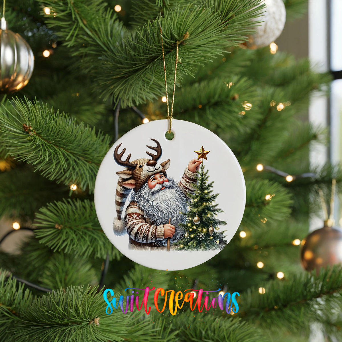 Round ceramic Christmas ornament featuring Santa placing a star on a Christmas tree, hanging on a green Christmas tree