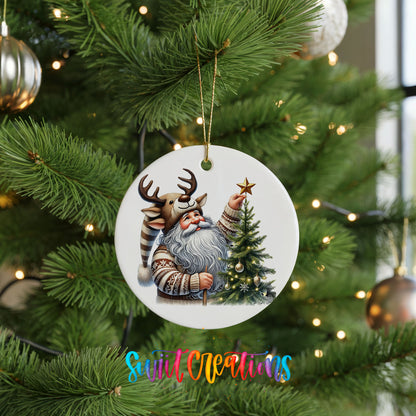 Round ceramic Christmas ornament featuring Santa placing a star on a Christmas tree, hanging on a green Christmas tree