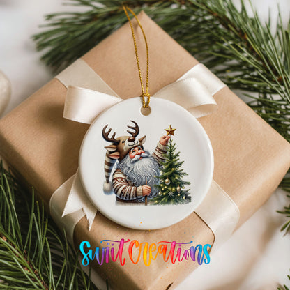 Round ceramic Christmas ornament featuring Santa placing a star on a Christmas tree, placed on a wrapped Christmas gift