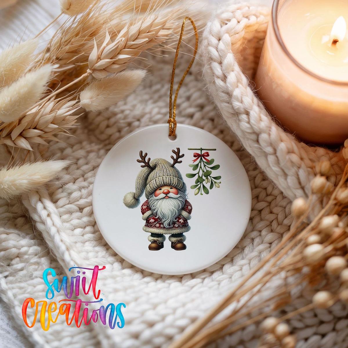 Round ceramic Christmas ornament featuring Santa standing beneath Christmas mistletoe, styled beside a candle and cozy knit blanket