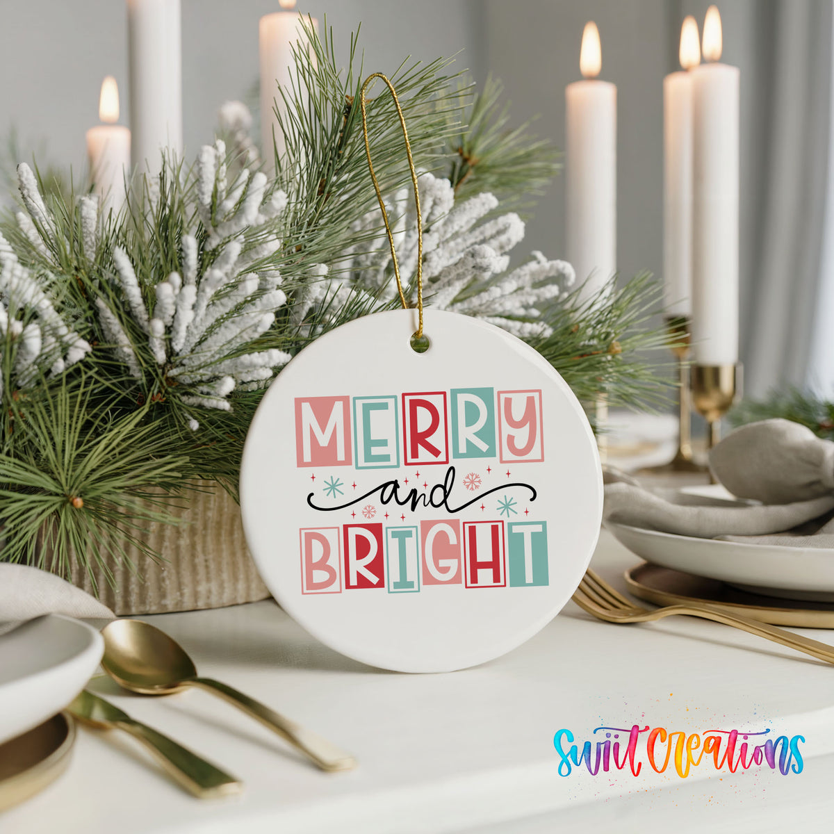 Round ceramic Christmas ornament featuring pastel block-letter Merry and Bright holiday typography, styled with elegant holiday table decor