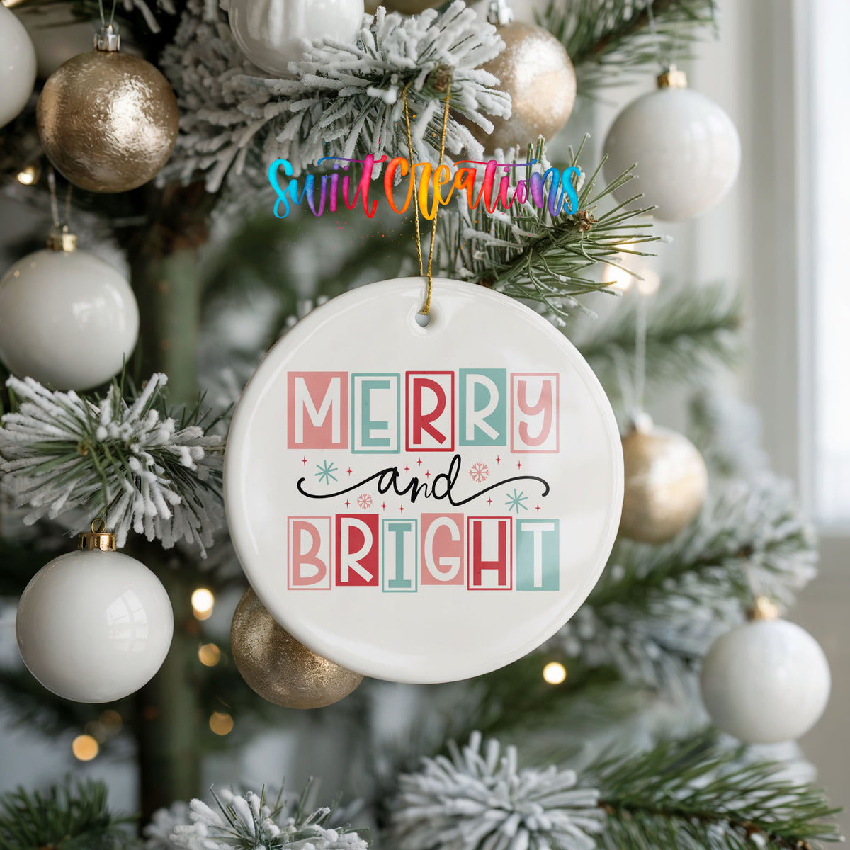 Round ceramic Christmas ornament featuring pastel block-letter Merry and Bright holiday typography, hanging on a frosted holiday tree
