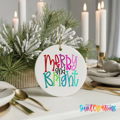 Round ceramic Christmas ornament featuring colorful hand-lettered Merry and Bright holiday typography, styled with elegant holiday table decor