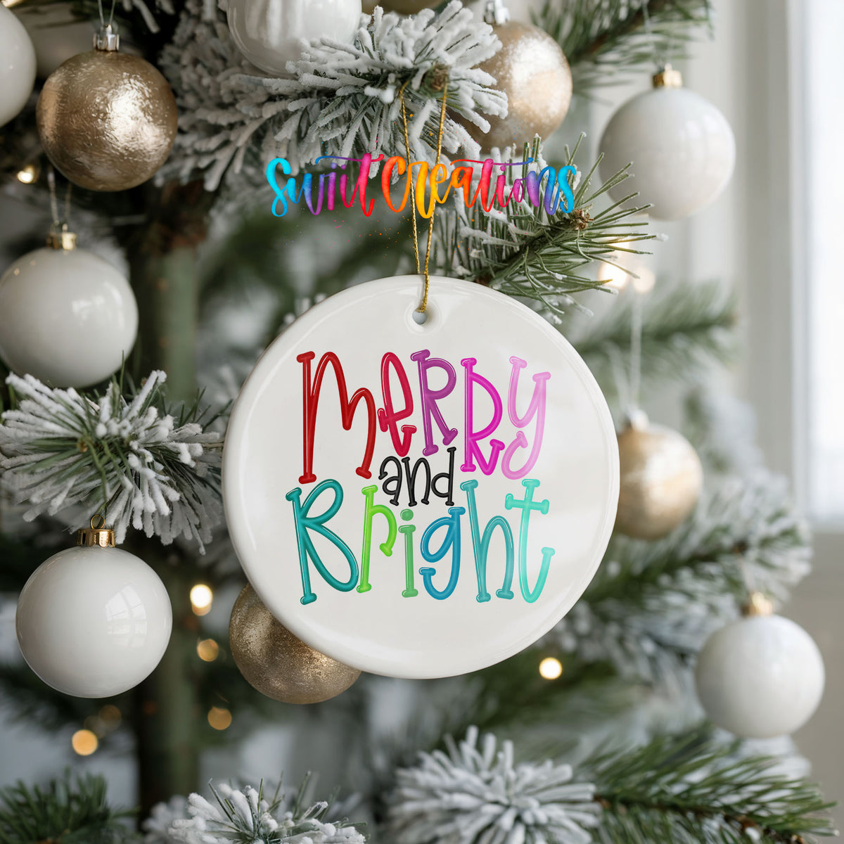 Round ceramic Christmas ornament featuring colorful hand-lettered Merry and Bright holiday typography, hanging on a frosted holiday tree