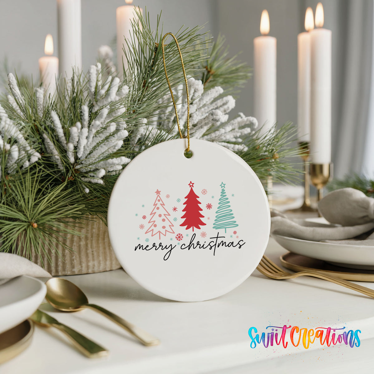 Round ceramic Christmas ornament featuring minimalist red and mint Christmas trees with Merry Christmas script, styled with elegant holiday table decor