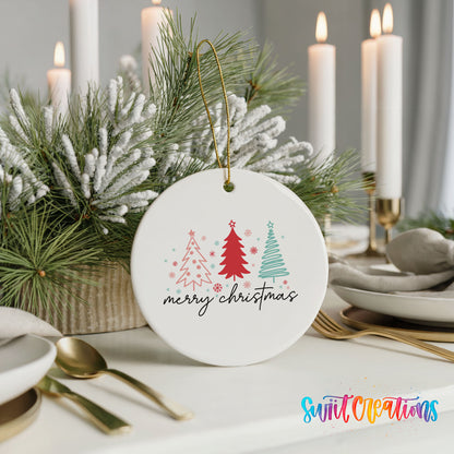 Round ceramic Christmas ornament featuring minimalist red and mint Christmas trees with Merry Christmas script, styled with elegant holiday table decor