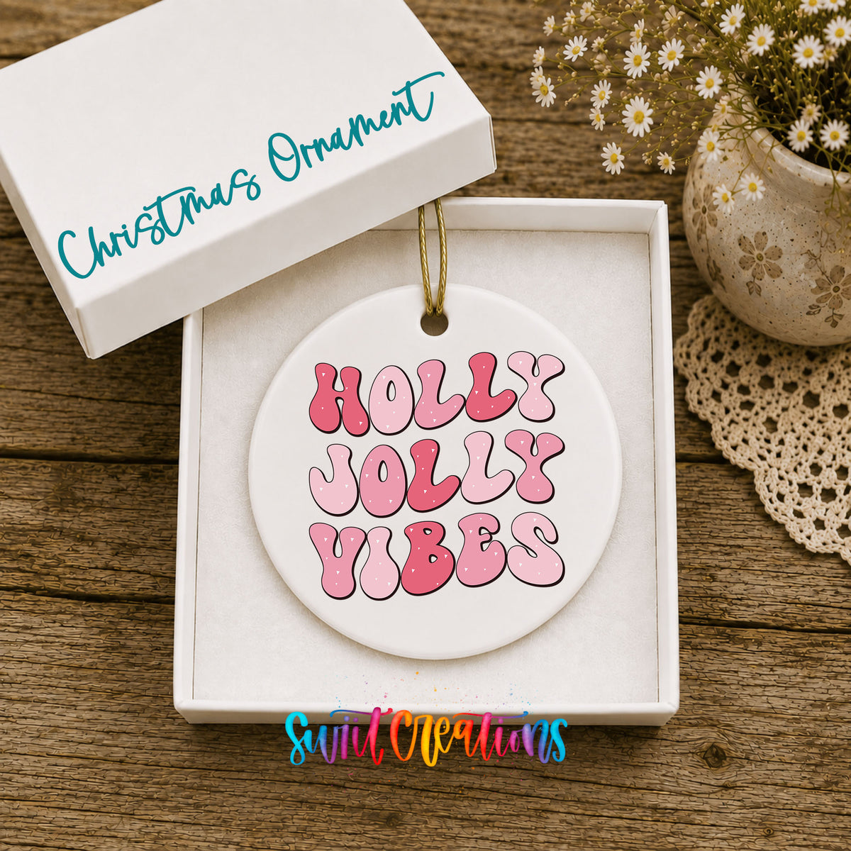 Round ceramic Christmas ornament featuring pink retro Holly Jolly Vibes typography, displayed in the included gift box