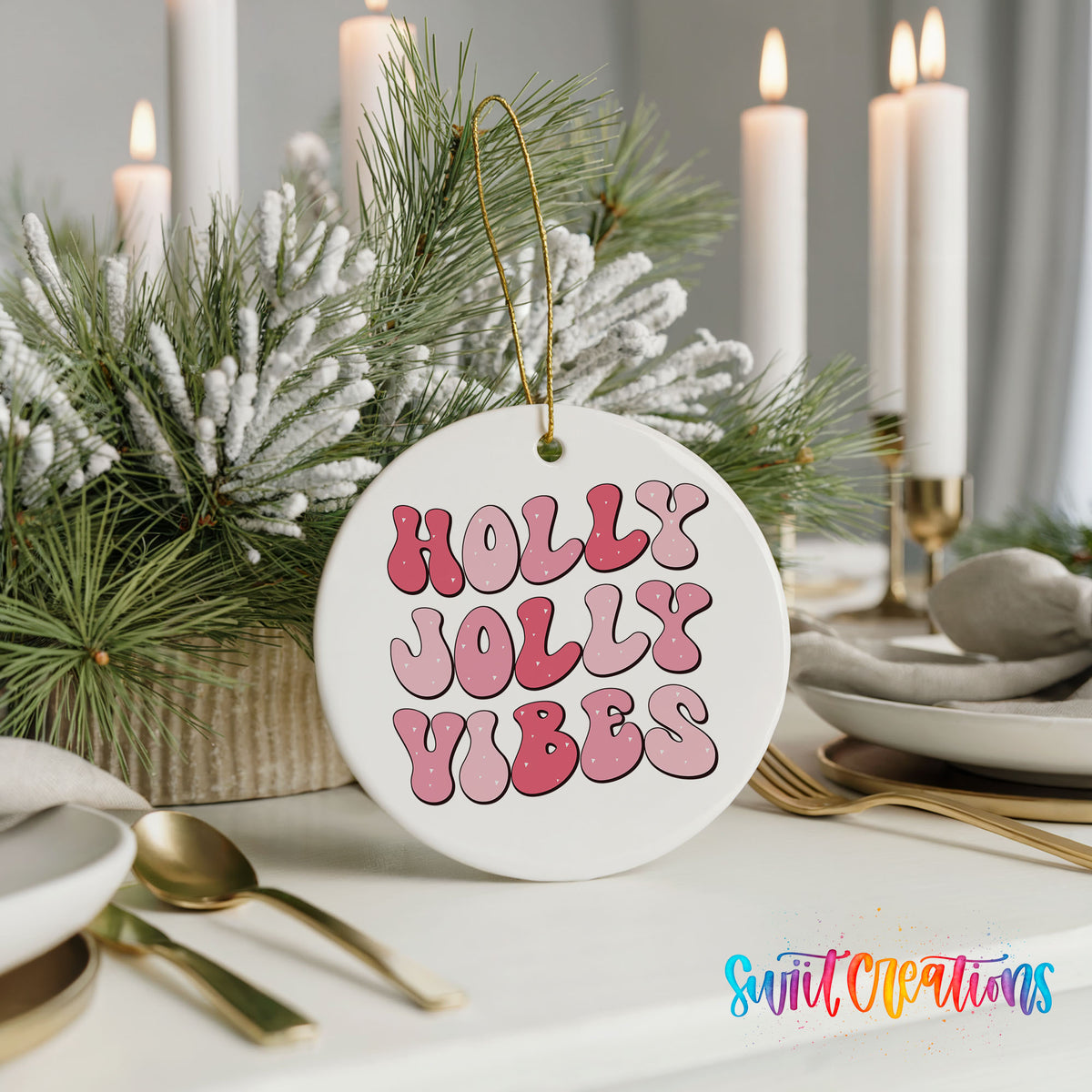 Round ceramic Christmas ornament featuring pink retro Holly Jolly Vibes typography, styled with elegant holiday table decor