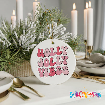 Round ceramic Christmas ornament featuring pink retro Holly Jolly Vibes typography, styled with elegant holiday table decor