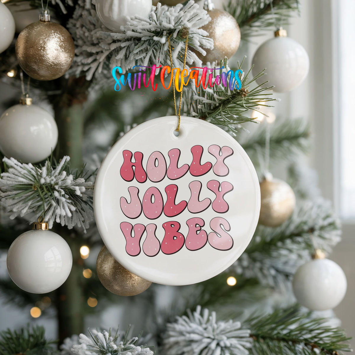 Round ceramic Christmas ornament featuring pink retro Holly Jolly Vibes typography, hanging on a frosted holiday tree