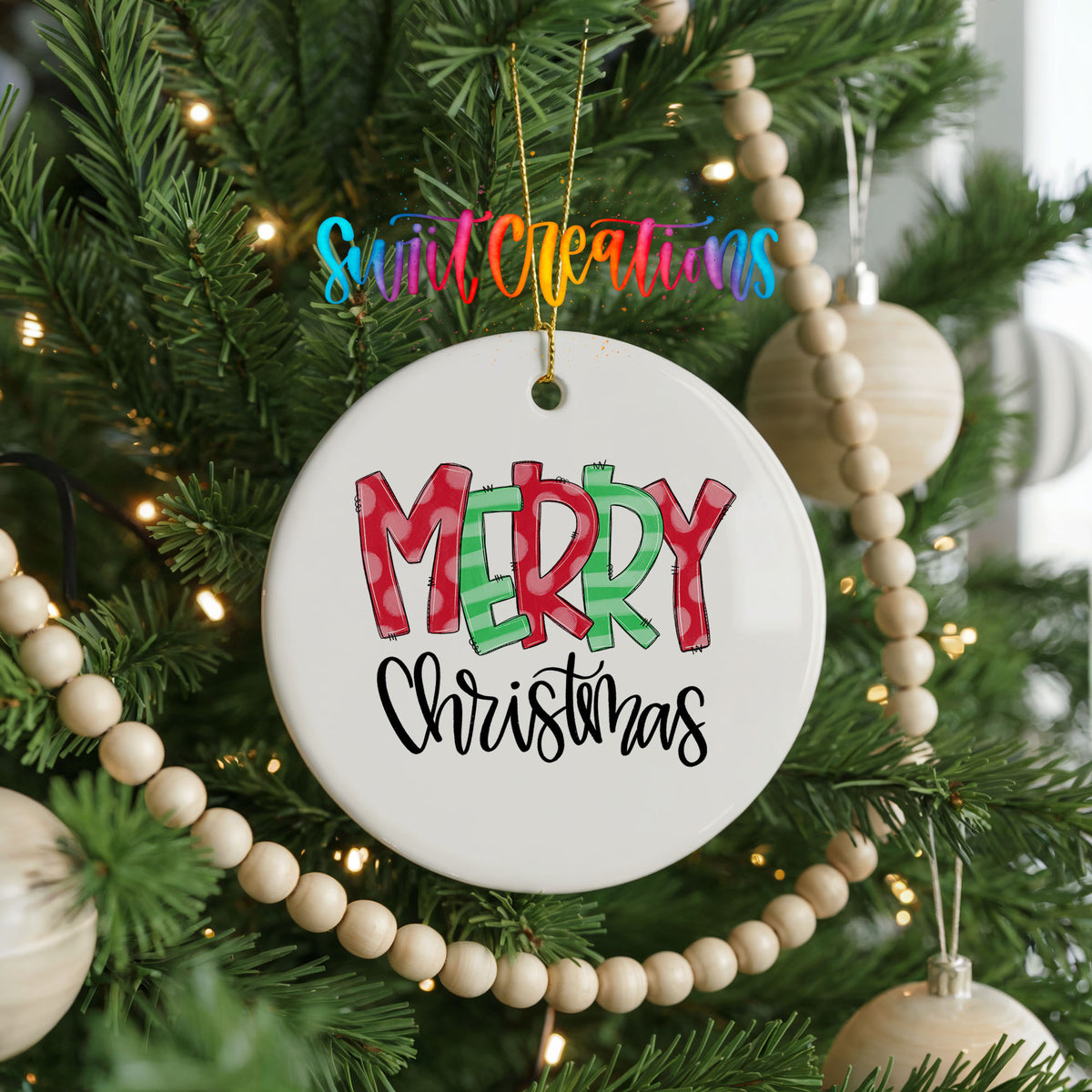 Round ceramic Christmas ornament featuring colorful patterned Merry Christmas typography, hanging on a decorated Christmas tree