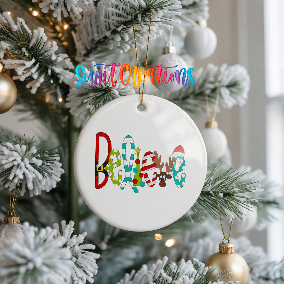 Round ceramic Christmas ornament featuring colorful whimsical Believe holiday lettering, hanging on a frosted Christmas tree