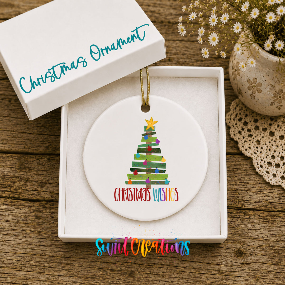 Round ceramic Christmas ornament featuring colorful pallet-style Christmas tree with Christmas Wishes lettering, displayed in the included gift box