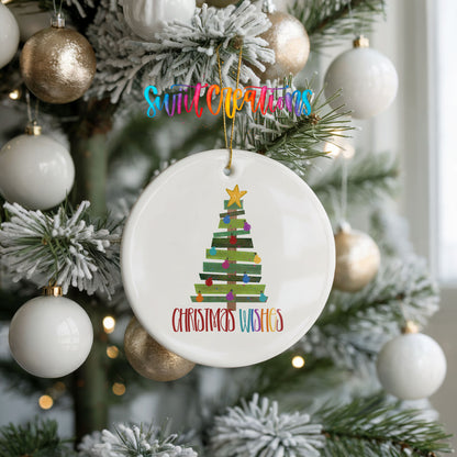 Round ceramic Christmas ornament featuring colorful pallet-style Christmas tree with Christmas Wishes lettering, hanging on a frosted holiday tree