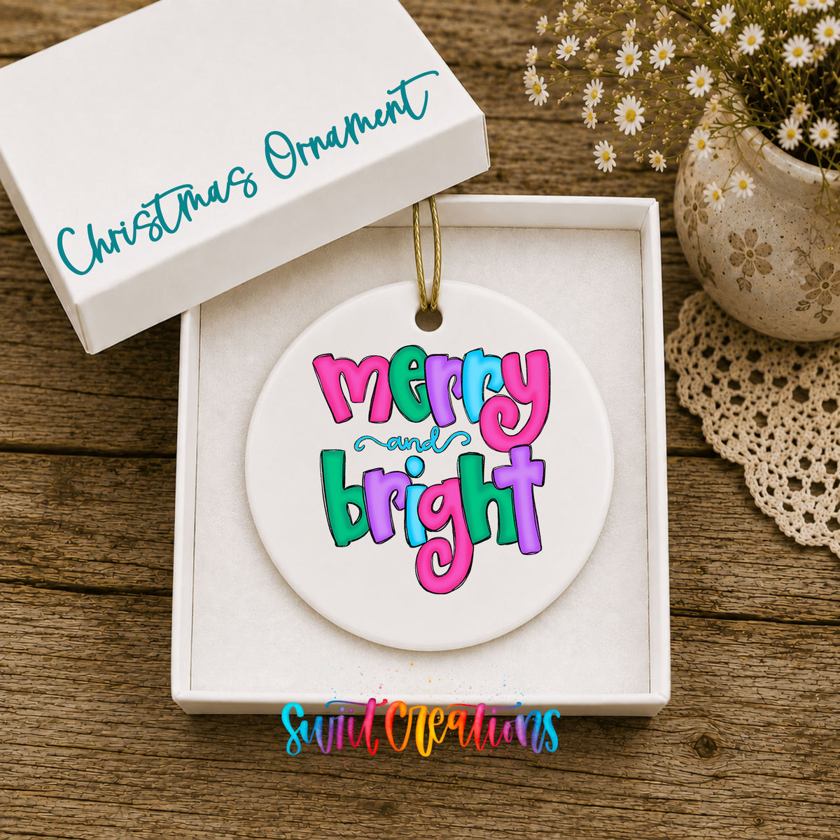 Round ceramic Christmas ornament featuring bright groovy Merry and Bright lettering in pink teal and purple, displayed in the included gift box