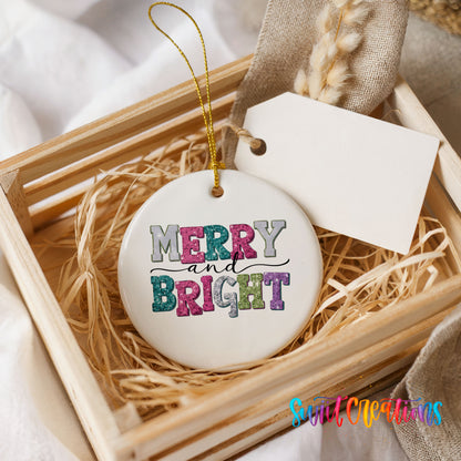 Round ceramic Christmas ornament featuring distressed patchwork Merry and Bright holiday typography, presented in a rustic wooden gift crate