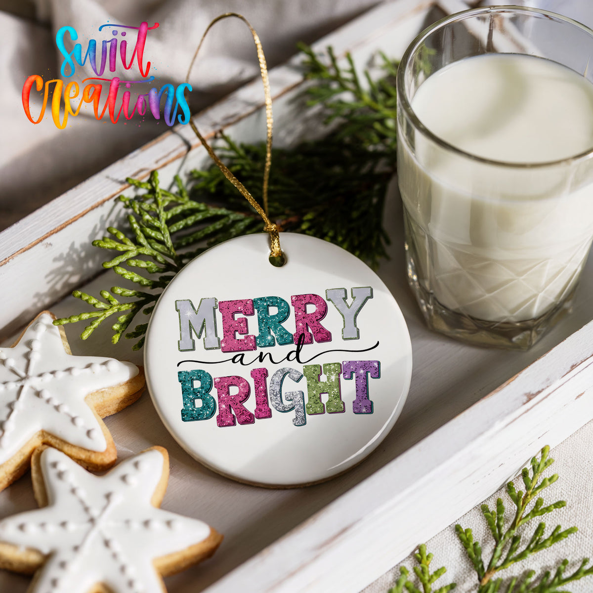 Round ceramic Christmas ornament featuring distressed patchwork Merry and Bright holiday typography, styled with cookies and milk