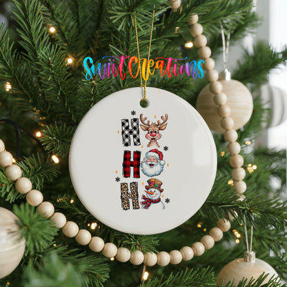 Round ceramic Christmas ornament featuring stacked Ho Ho Ho lettering with cheerful holiday characters, hanging on a decorated Christmas tree