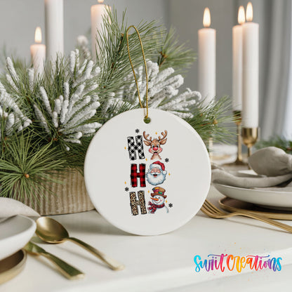 Round ceramic Christmas ornament featuring stacked Ho Ho Ho lettering with cheerful holiday characters, styled with elegant holiday table decor