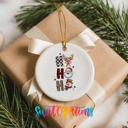 Round ceramic Christmas ornament featuring stacked Ho Ho Ho lettering with cheerful holiday characters, placed on a wrapped Christmas gift