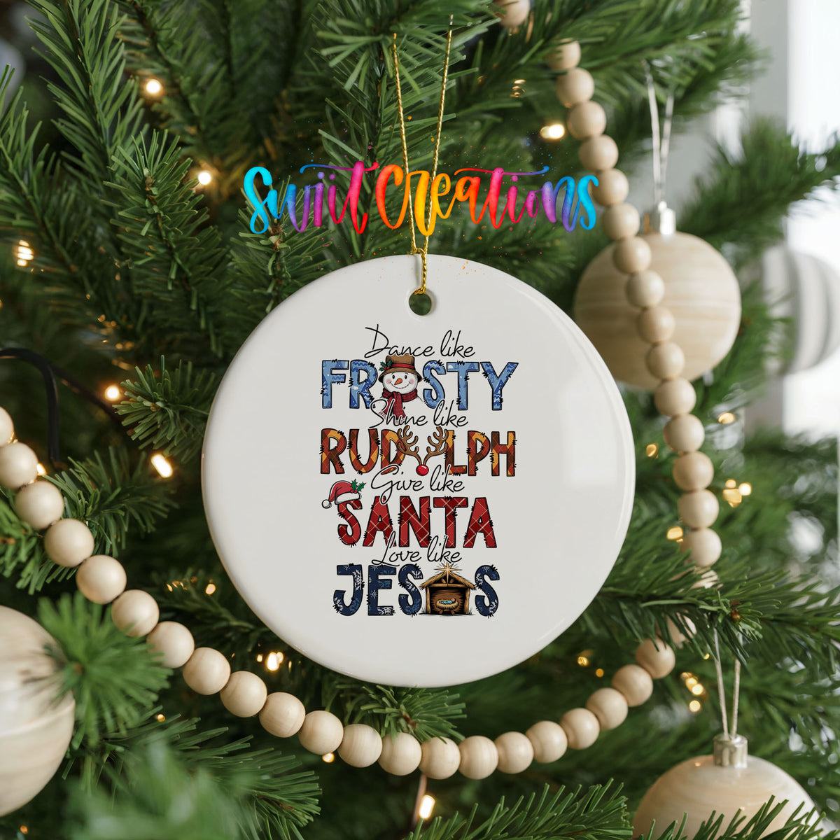Round ceramic Christmas ornament featuring Dance like Frosty ride like Rudolph give like Santa love like Jesus message, hanging on a decorated Christmas tree