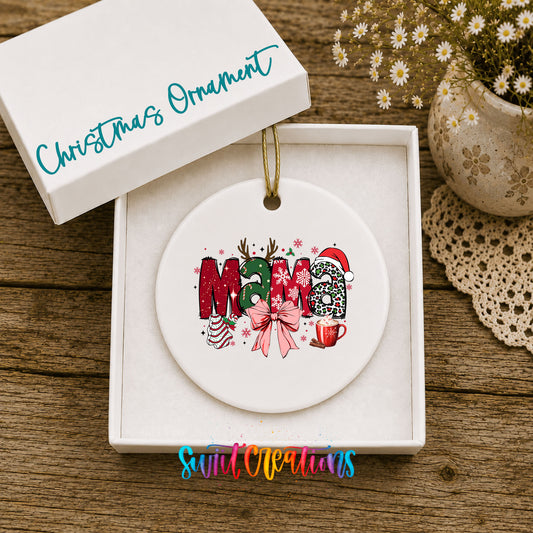 Round ceramic Christmas ornament featuring festive patterned Mama lettering with a large red holiday bow, displayed in the included gift box