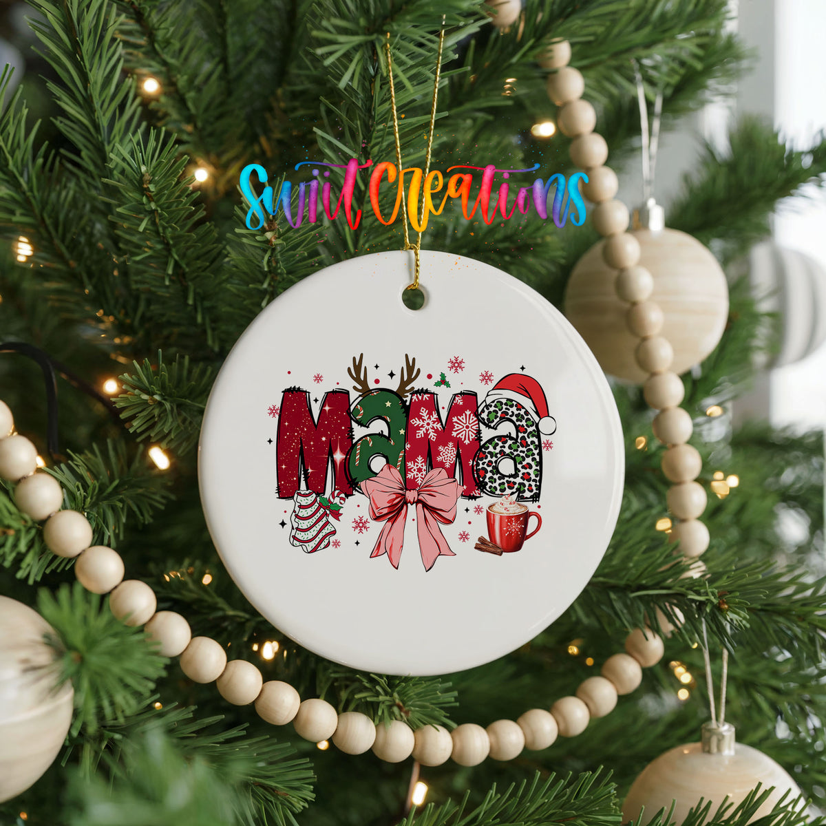 Round ceramic Christmas ornament featuring festive patterned Mama lettering with a large red holiday bow, hanging on a decorated Christmas tree