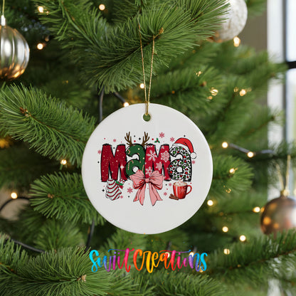 Round ceramic Christmas ornament featuring festive patterned Mama lettering with a large red holiday bow, hanging on a green Christmas tree