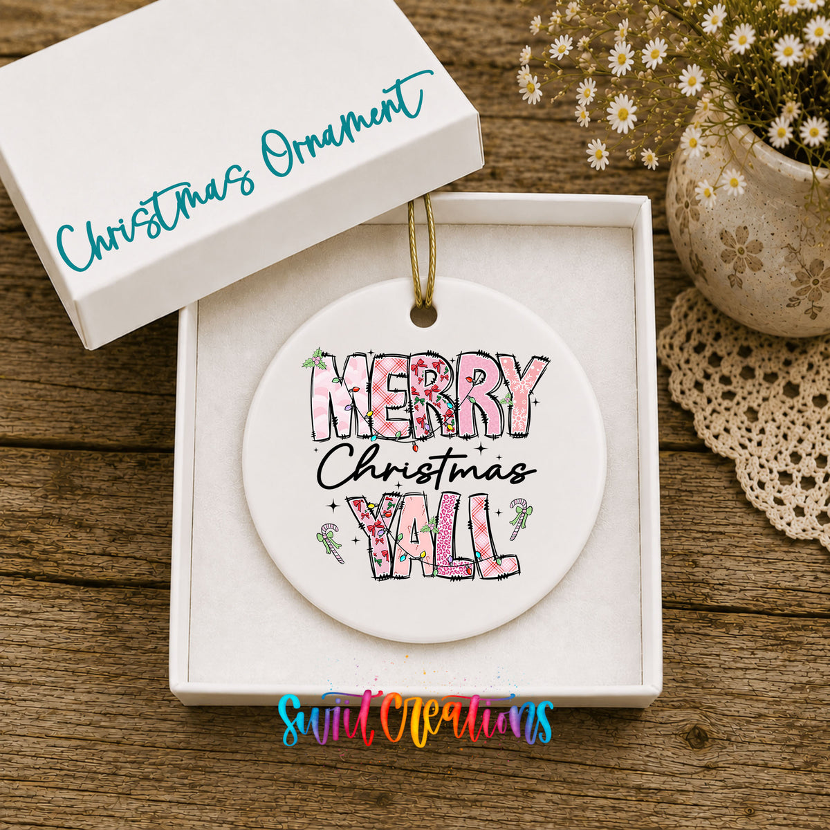 Round ceramic Christmas ornament featuring patterned Merry Christmas Y’all lettering with pink and green accents, displayed in the included gift box