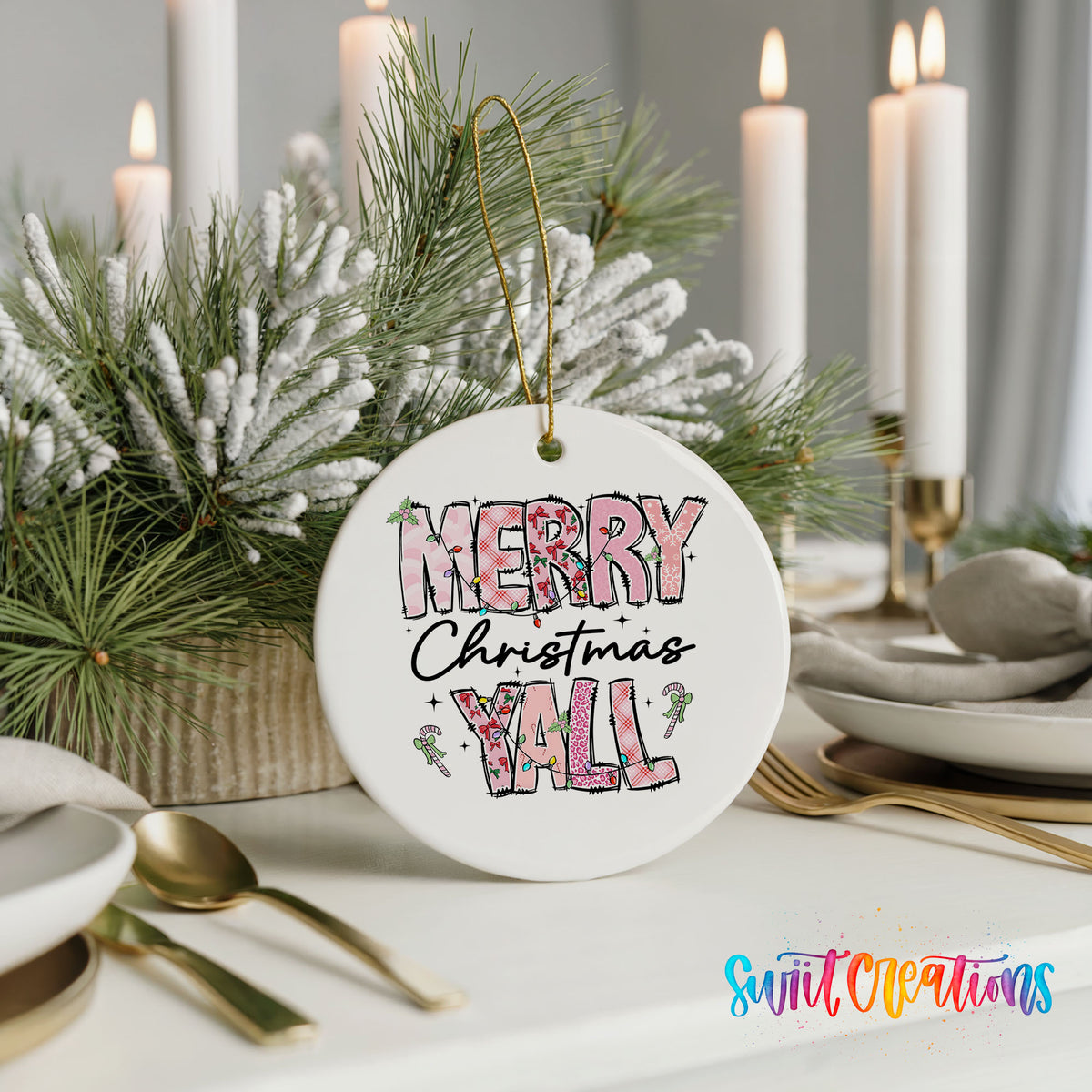 Round ceramic Christmas ornament featuring patterned Merry Christmas Y’all lettering with pink and green accents, styled with elegant holiday table decor