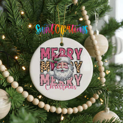 Round ceramic Christmas ornament featuring stacked Merry Merry Merry Christmas lettering with Santa and leopard print accents, hanging on a decorated Christmas tree