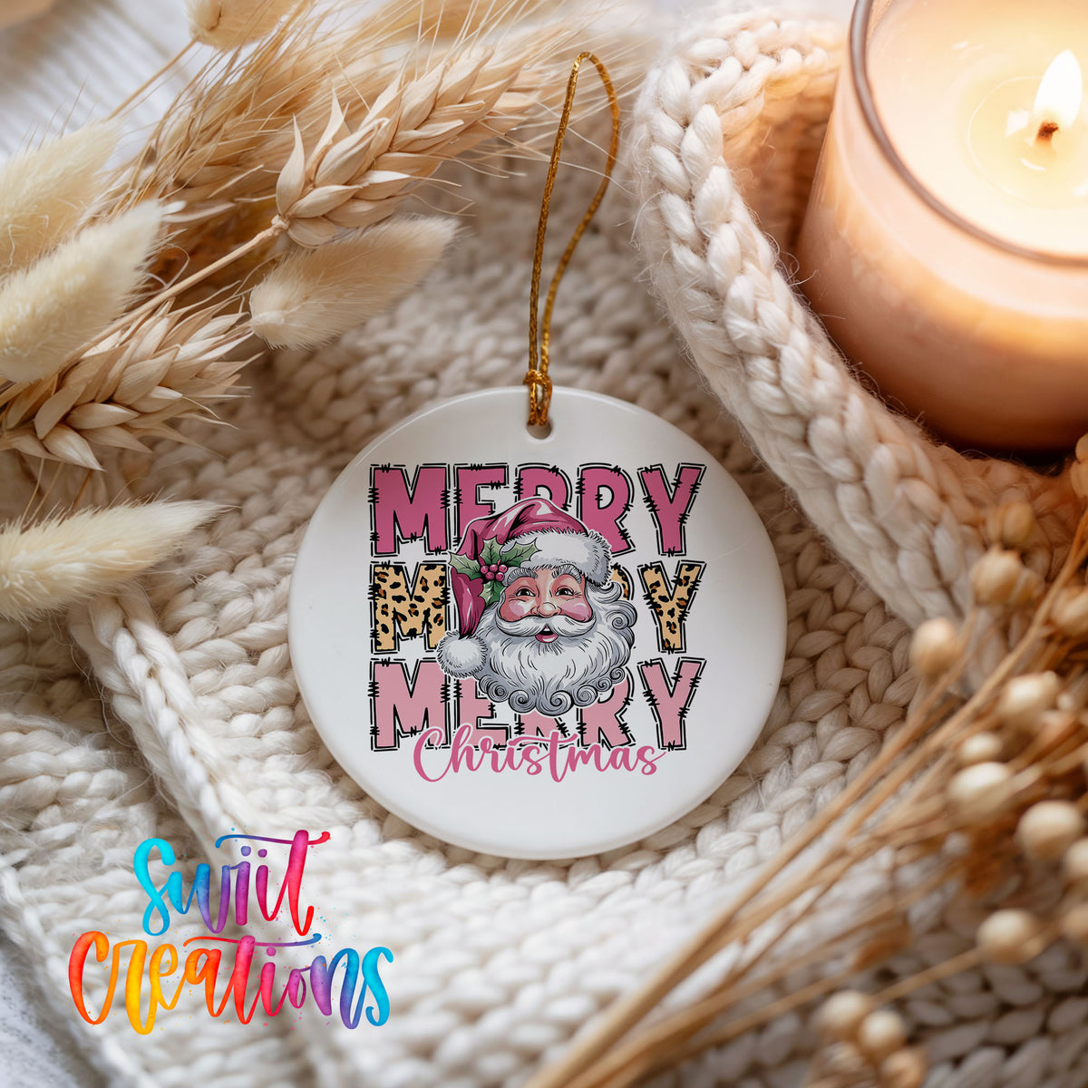 Round ceramic Christmas ornament featuring stacked Merry Merry Merry Christmas lettering with Santa and leopard print accents, styled beside a candle and cozy knit blanket