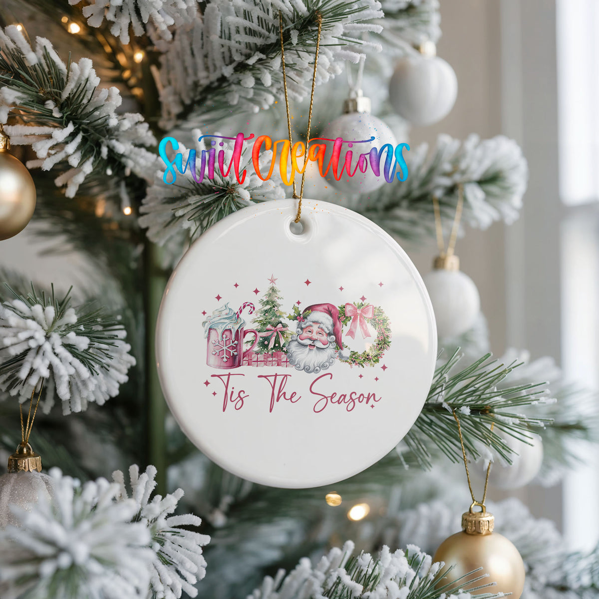 Round ceramic Christmas ornament featuring vintage Santa with floral greenery and ’Tis the Season lettering, hanging on a frosted Christmas tree