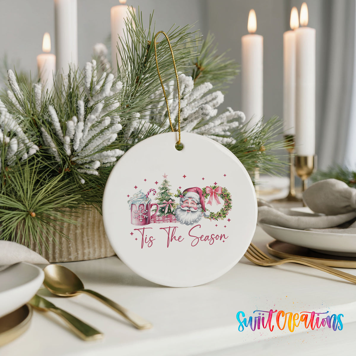 Round ceramic Christmas ornament featuring vintage Santa with floral greenery and ’Tis the Season lettering, styled with elegant holiday table decor