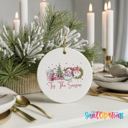 Round ceramic Christmas ornament featuring vintage Santa with floral greenery and ’Tis the Season lettering, styled with elegant holiday table decor