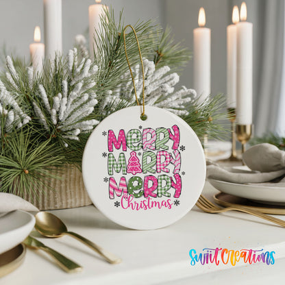 Round ceramic Christmas ornament featuring stacked patterned Merry Merry Merry Christmas lettering in pink and green, styled with elegant holiday table decor