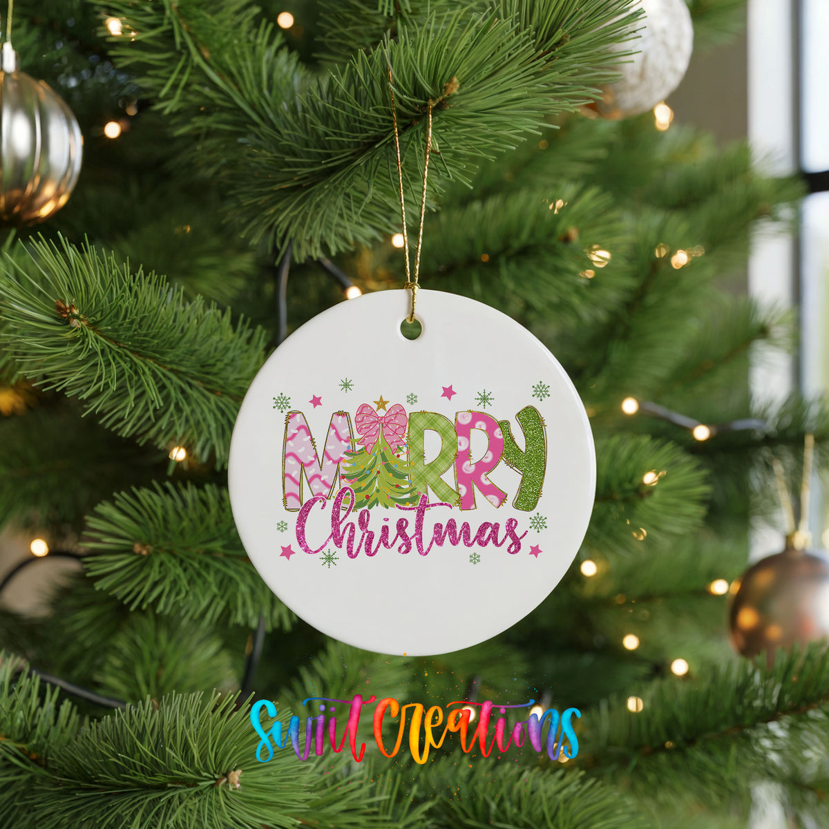 Round ceramic Christmas ornament featuring bright Merry Christmas lettering with candy stripe and floral details, hanging on a green Christmas tree