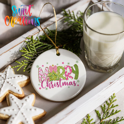 Round ceramic Christmas ornament featuring bright Merry Christmas lettering with candy stripe and floral details, styled with cookies and milk